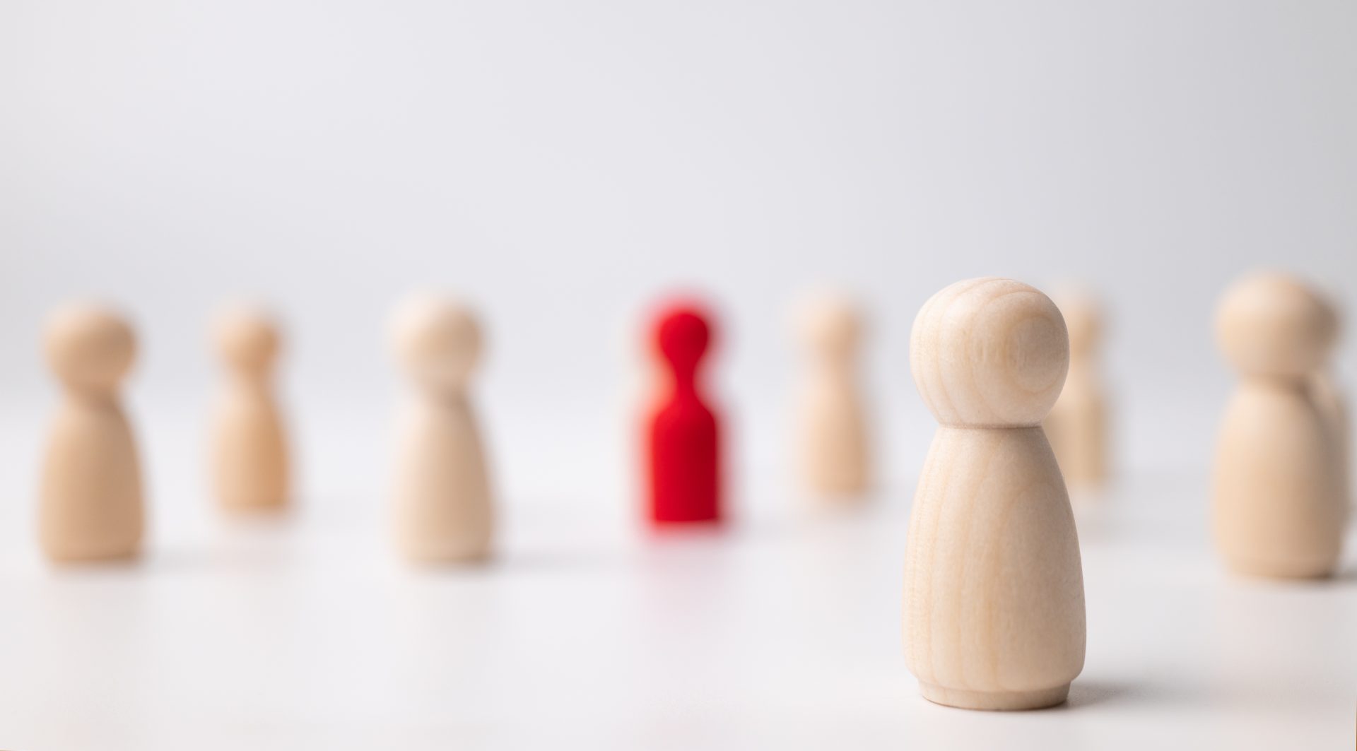 wooden-figure-standing-with-team-influence-empowerment